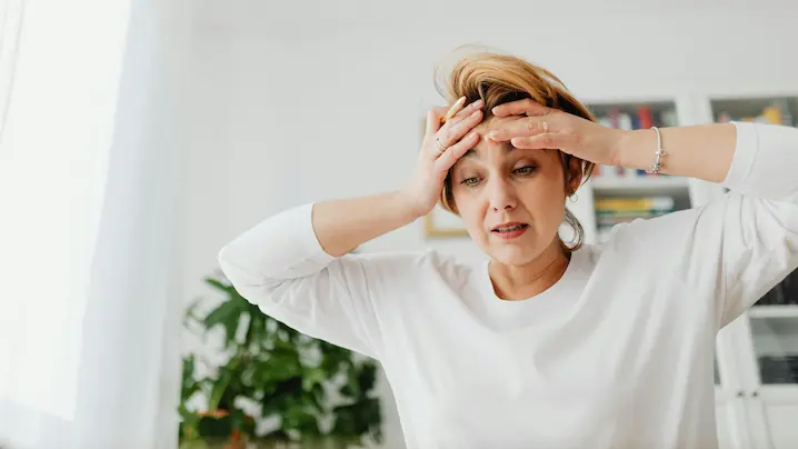 a woman with her head in her hands